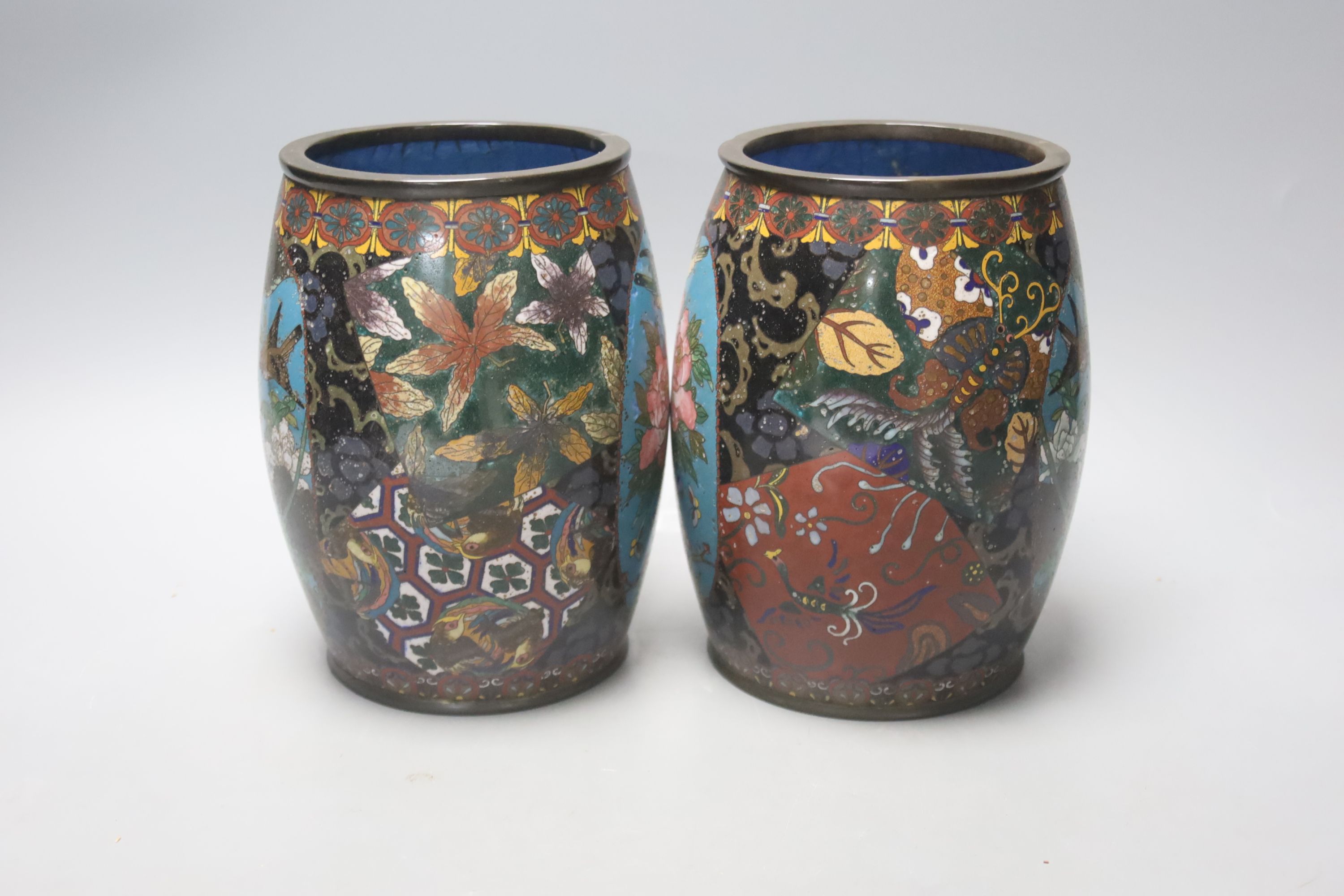 A pair of Japanese cloisonne enamel barrel-shaped vases and a similar bottle vase